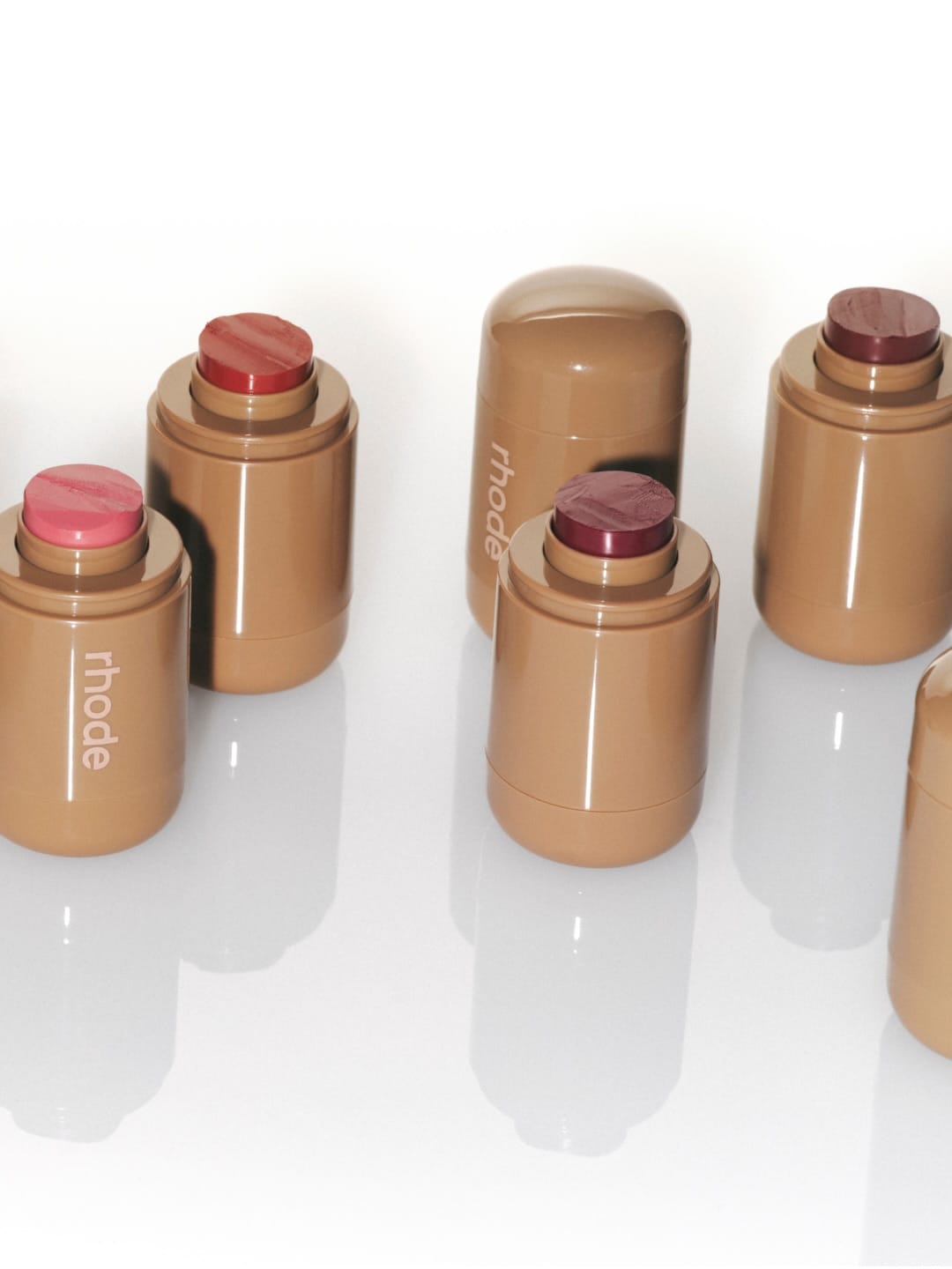 Rhode Skin blush sticks product photo: caramel tan, sand beige and berry pink, plastic, soft light, image 2 of 2