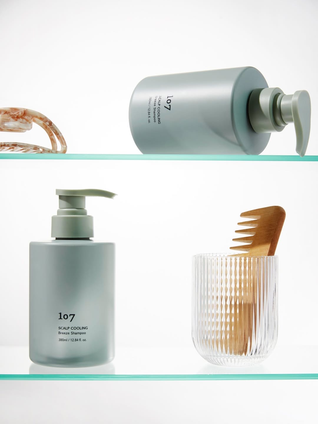 107 Beauty scalp care product photo: sage green, stone grey and clear glass, plastic and glass, bright light