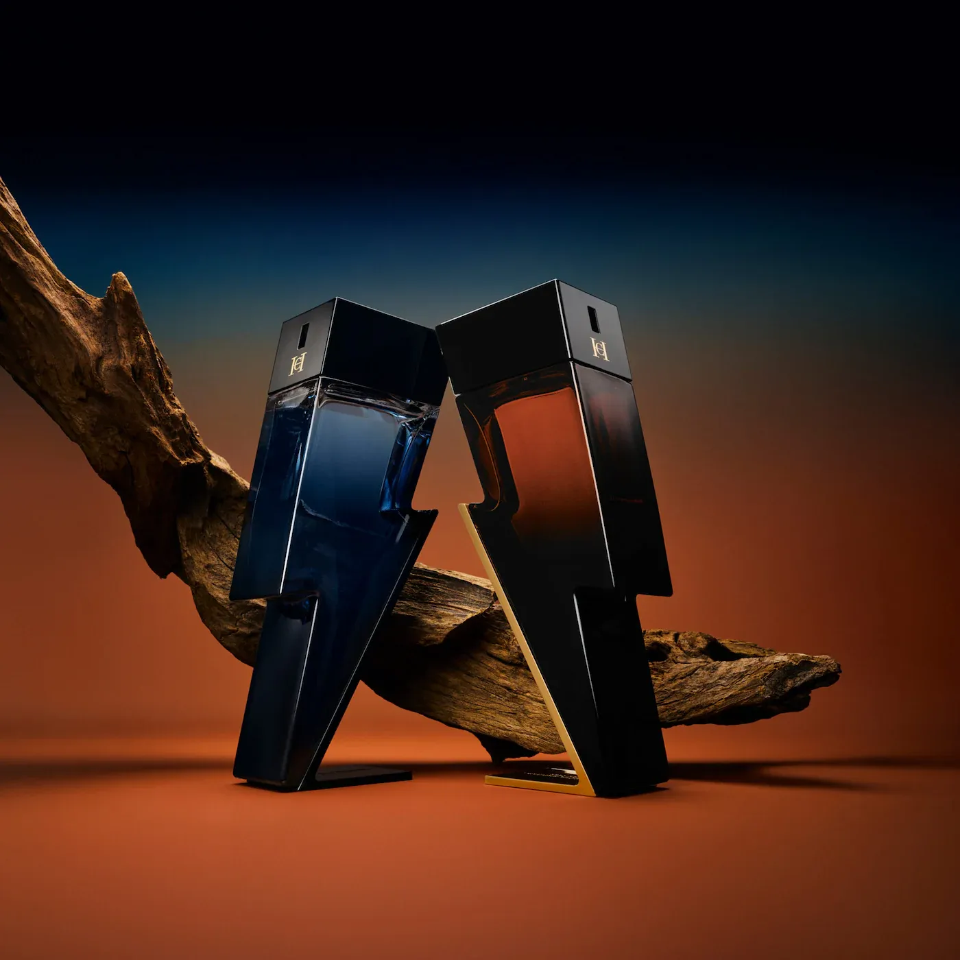 Carolina Herrera Bad Boy product photo: onyx black, burnt orange, navy blue and gold, glass, dramatic light