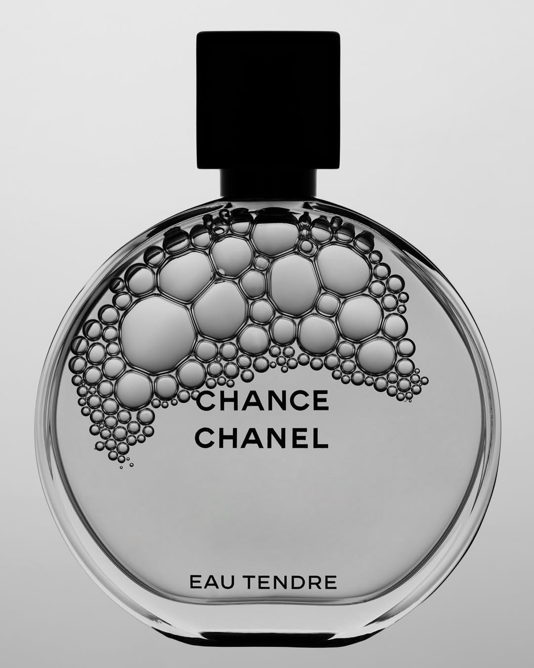 Chanel Chance Eau Tendre product photo: clear glass, black cap and silver grey, glass, studio light