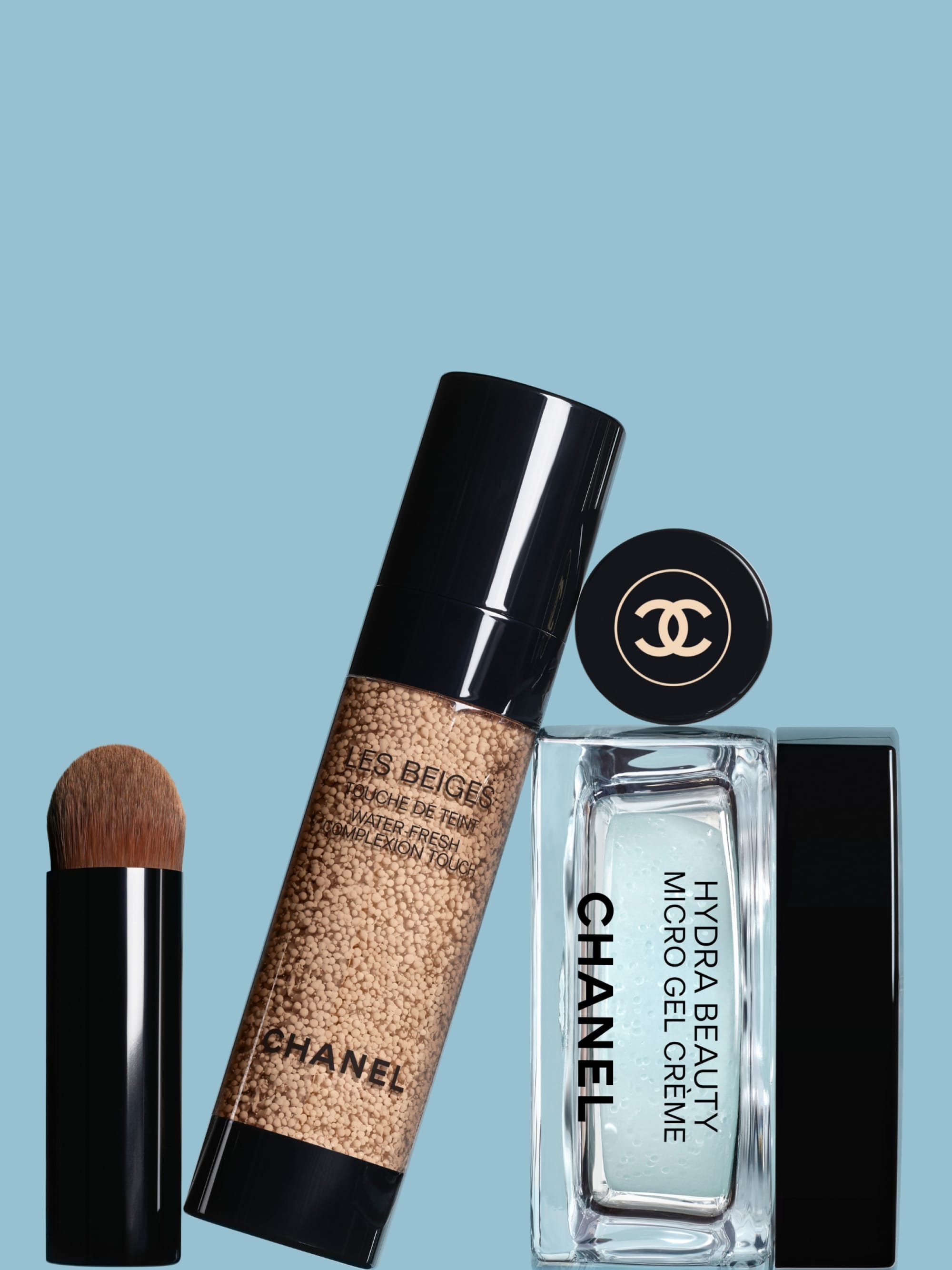 Chanel Hydra Beauty product photo: creamy white, gloss black, golden beige and clear aqua glass, plastic and glass, soft light, image 3 of 3