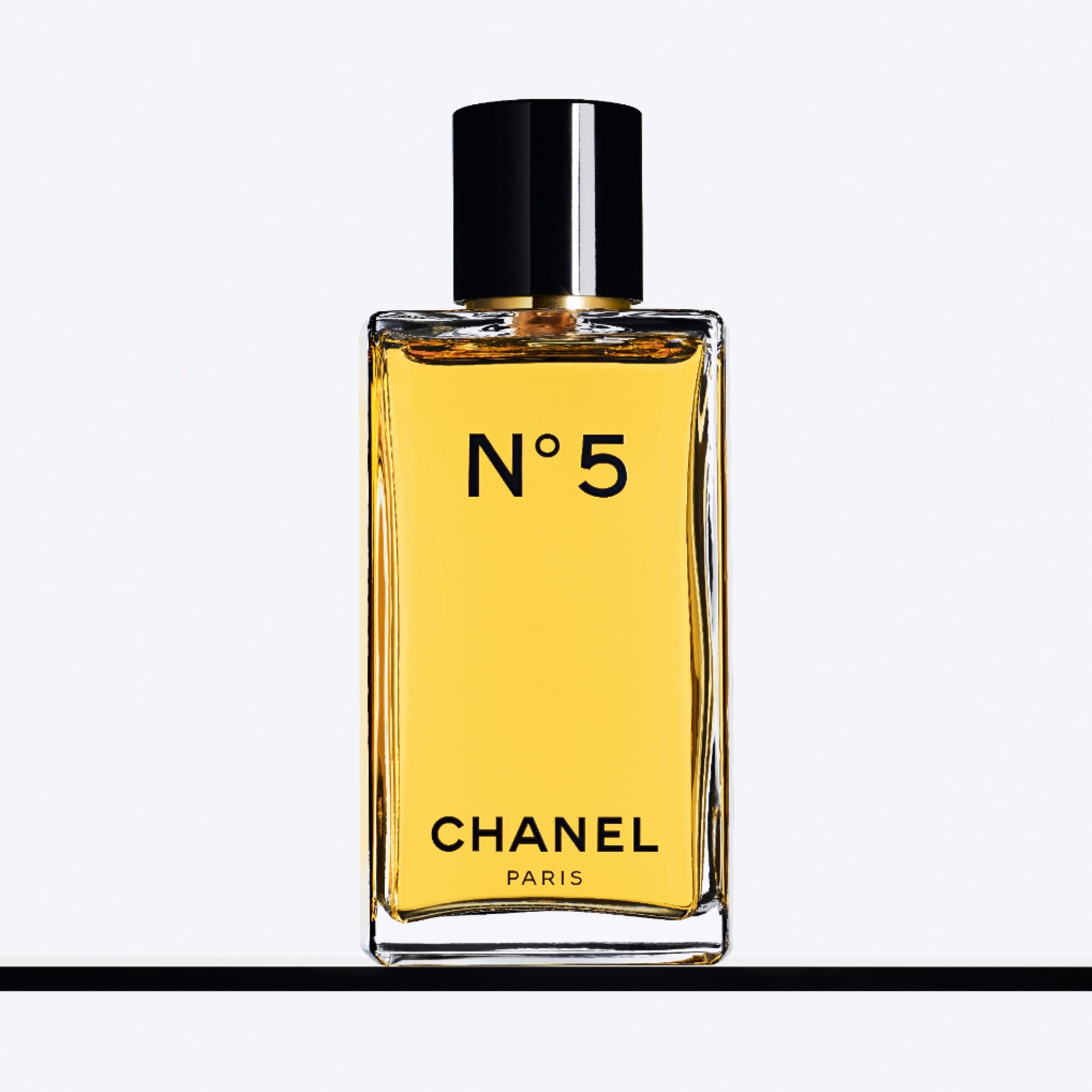 Chanel N°5 product photo: golden yellow, black cap and amber, glass, studio light, image 3 of 3