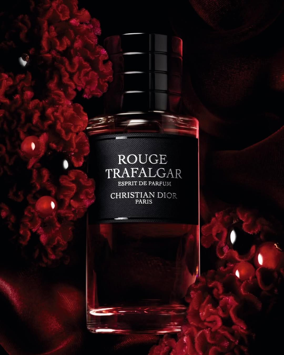 Dior Beauty fragrance product photo: black and deep red, glass, dramatic light