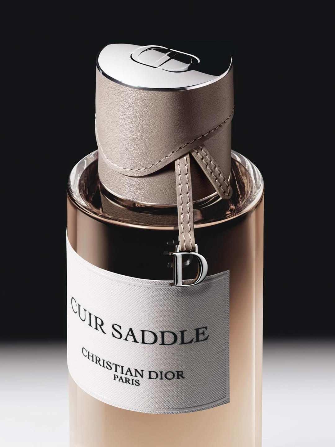 Dior's couture perfume caps product photo: amber beige, taupe leather, blush pink and black, metal, studio light, image 1 of 2