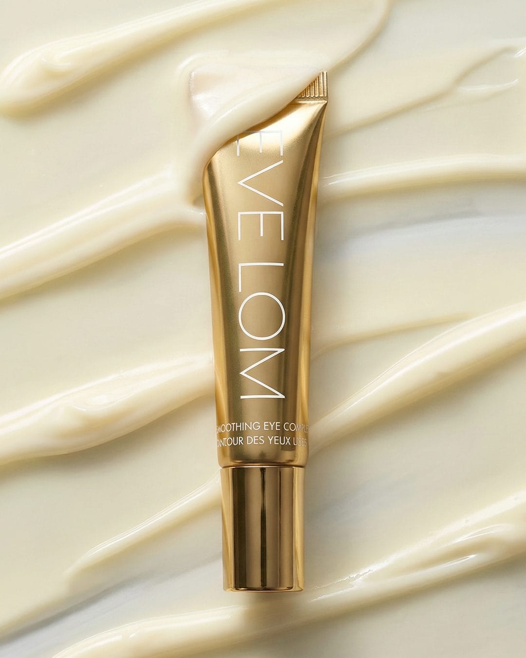 Eve Lom skincare product photo: polished gold, metal, soft light