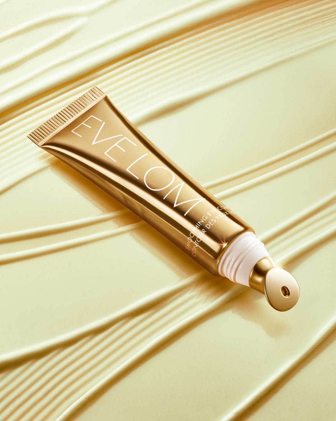 Eve Lom skincare product photo: polished gold, metal, soft light, image 2 of 2