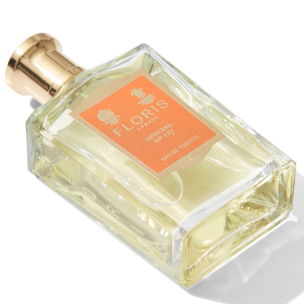 Floris Special No. 127 product photo: pale lemon, burnt orange, champagne gold and white box, glass, soft light