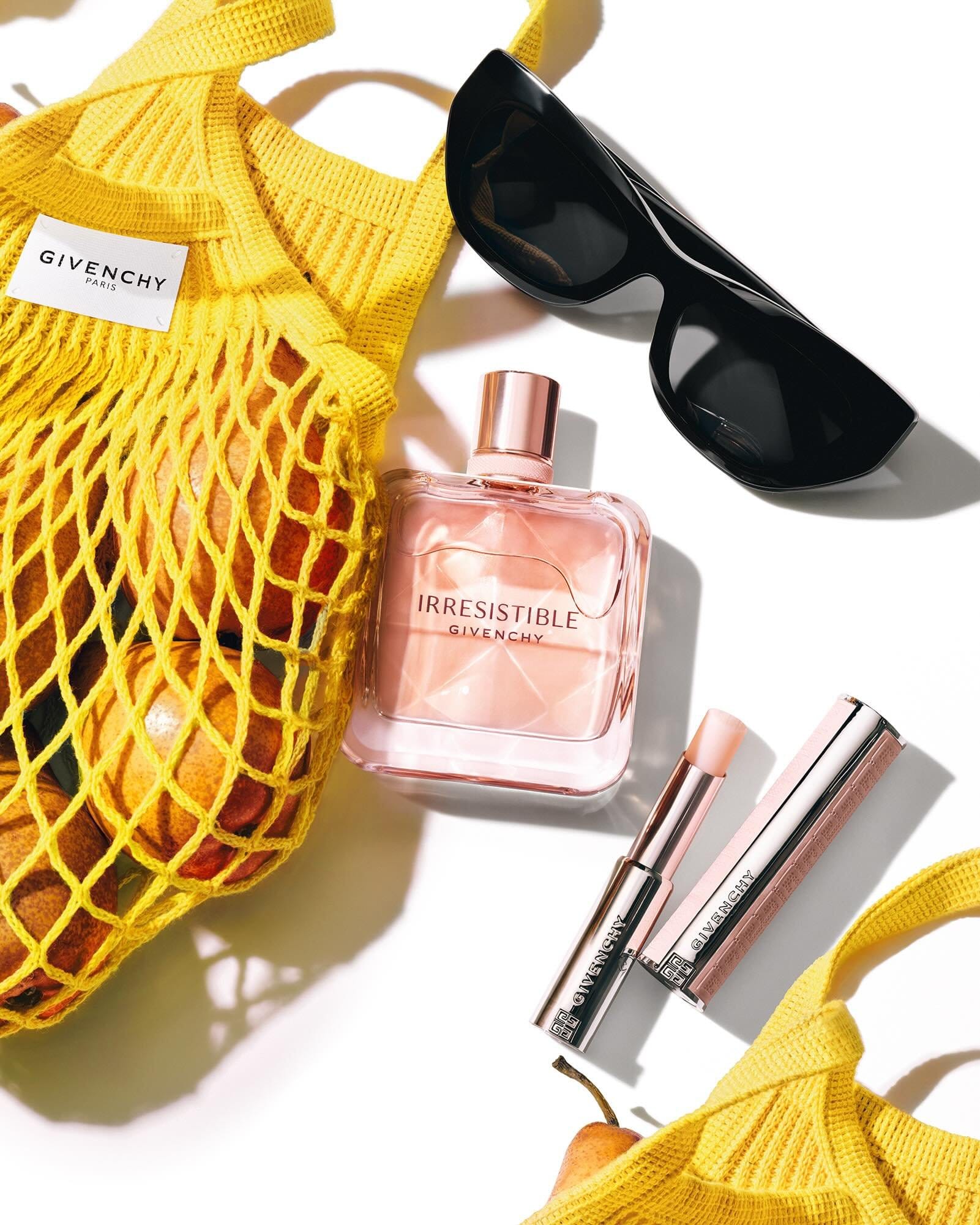 Givenchy beauty flat lay product photo: blush pink, clear glass and rose gold, fabric and glass, bright light