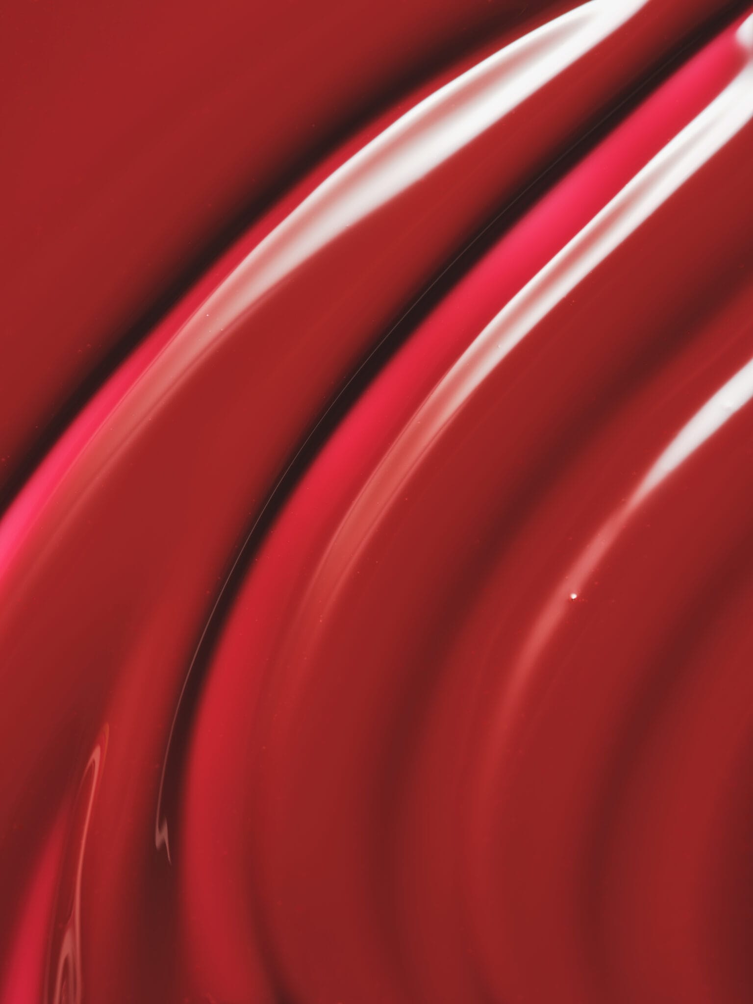 Glowery's mirror-shine lip oils product photo: cherry red and oxblood, glass, studio light, image 2 of 3
