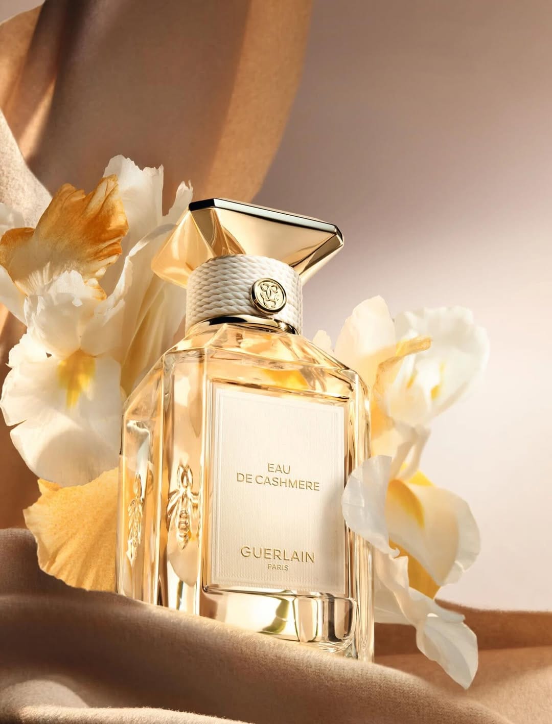 Guerlain fragrance photography product photo: champagne gold, blush pink, cream and pale green, glass, soft light