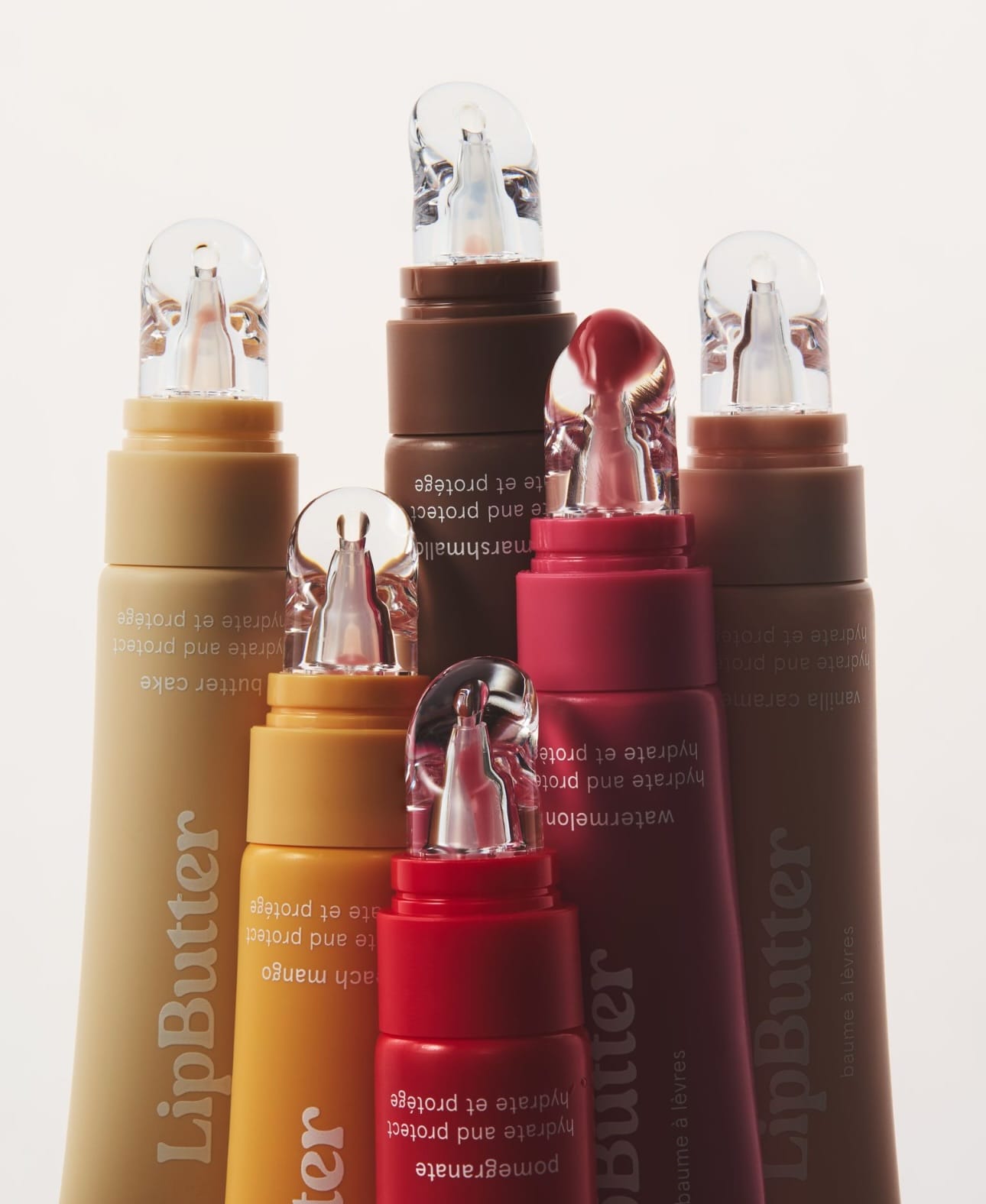 Kylie Cosmetics lip butters product photo: berry red, chocolate brown, caramel and apricot, plastic, soft light