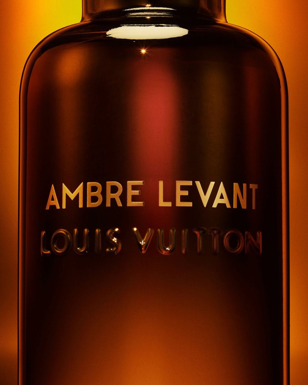 Louis Vuitton Ambre Levant product photo: dark amber, smoked black and gold lettering, glass, dramatic light