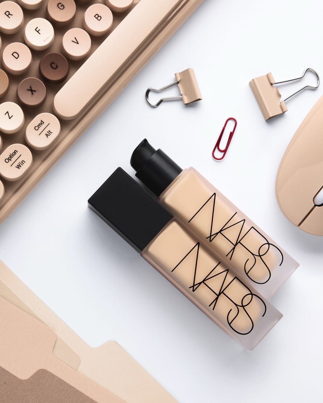 NARS foundation product photo: sand beige and matte black, paper and glass, soft light, image 2 of 2