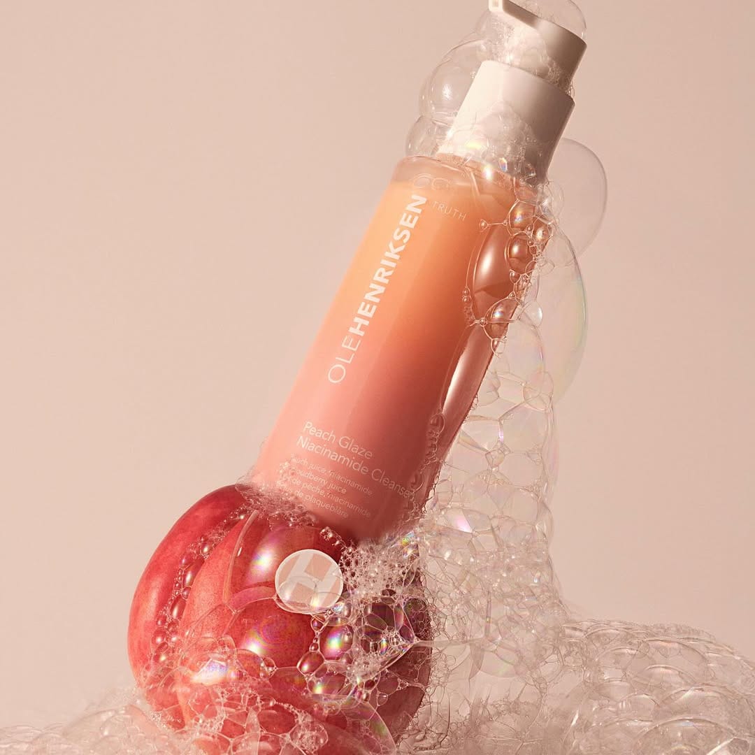 OLEHENRIKSEN Peach Glaze product photo: peach, coral pink and white, plastic and organic, soft light