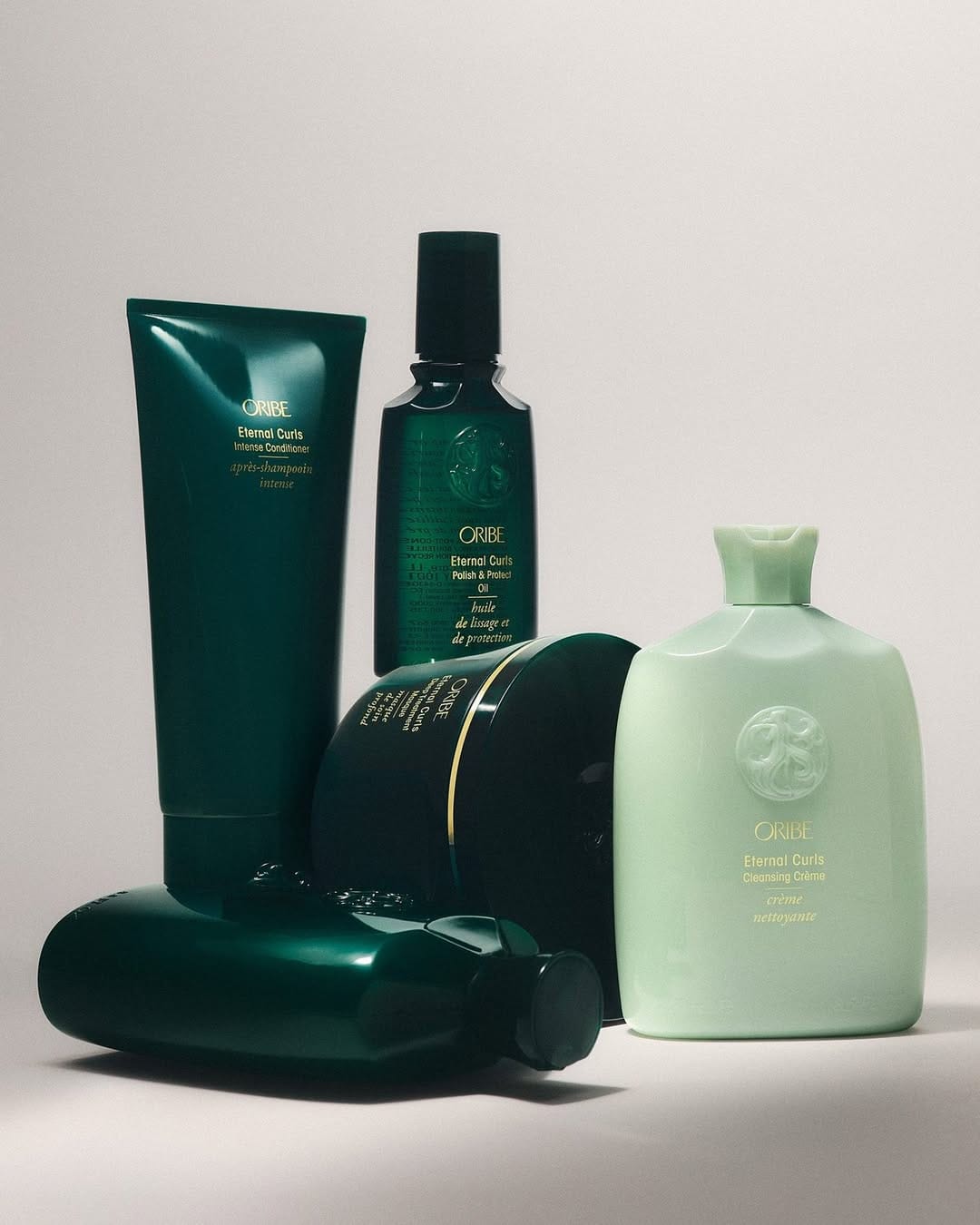 Oribe haircare product photo: forest green and mint green, plastic, soft light