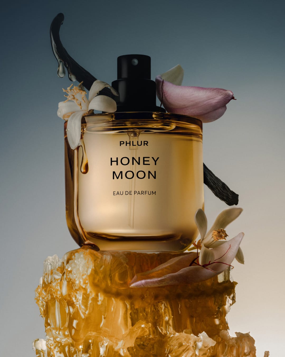 PHLUR's Honey Moon product photo: honey gold, cream white and black, glass and organic, dramatic light