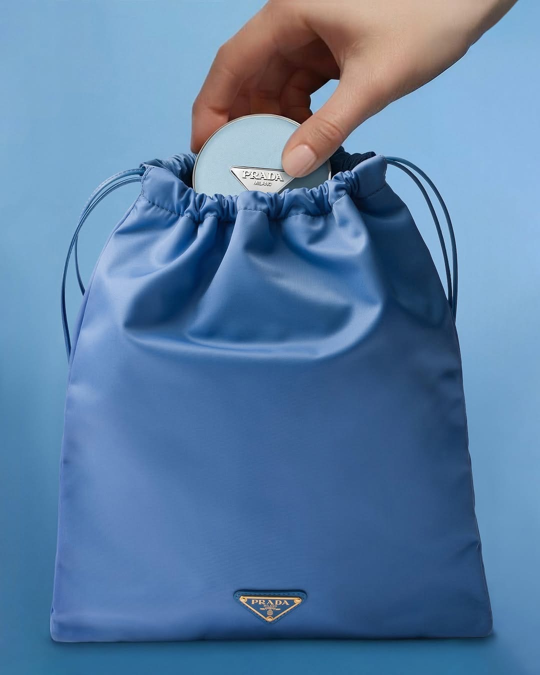 Prada Beauty product photo: periwinkle blue and brushed silver, fabric, soft light, image 2 of 2