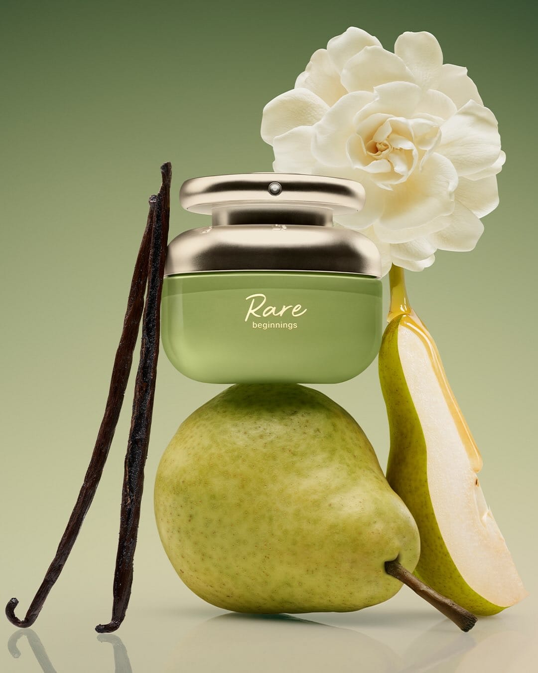Rare Beauty's Rare Beginnings fragrance product photo: pear green, brushed silver and champagne gold, organic, soft light