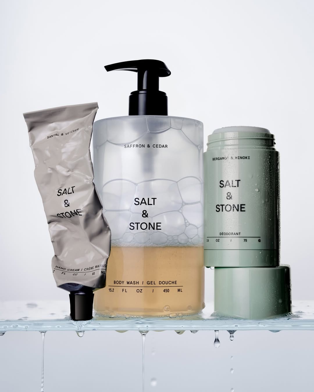 Salt & Stone body wash product photo: frosted clear, sage green, stone grey and black pump, plastic and glass, studio light