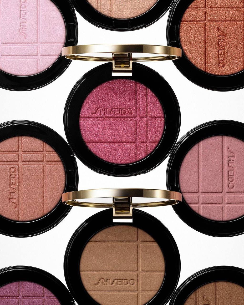 Shiseido campaign product photo: rose pink, black, gold ring and red, plastic, bright light