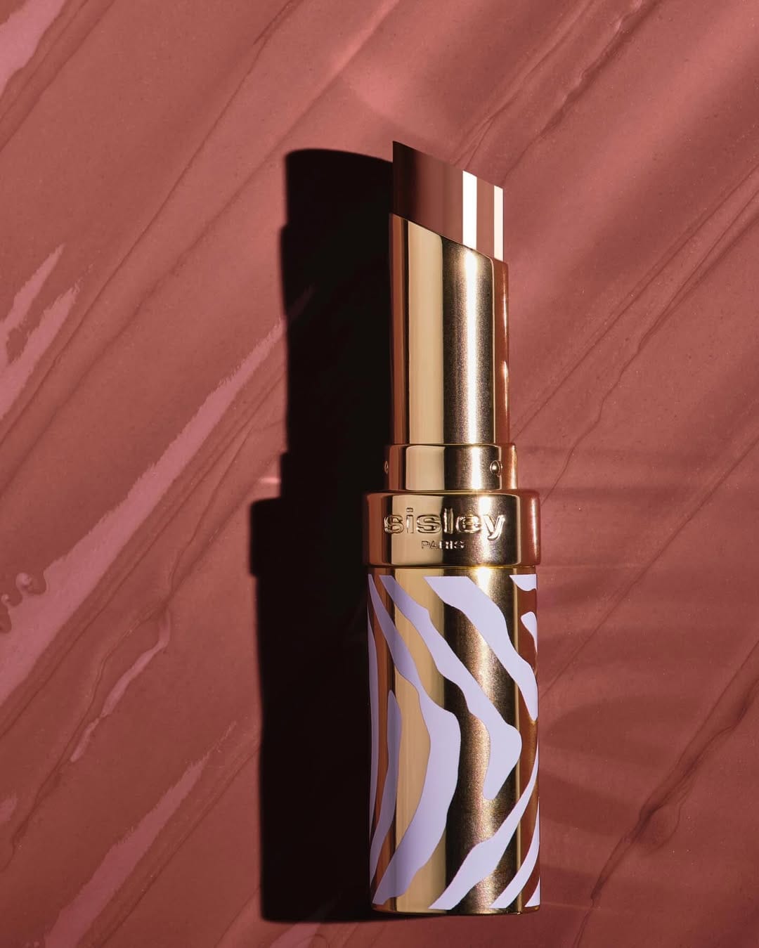 Sisley Paris lipstick product photo: gold, poppy red, chocolate brown and rosewood, metal, soft light