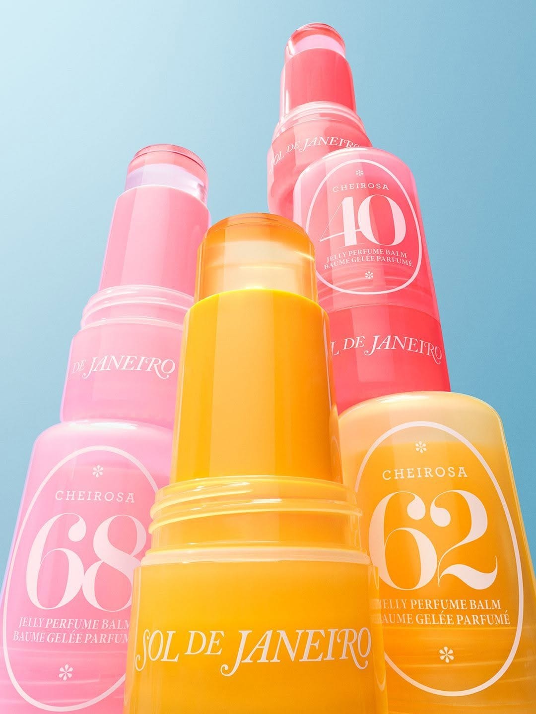 Sol de Janeiro Jelly Perfume Balms product photo: tangerine orange, bubblegum pink, sunny yellow and coral red, skin, natural light