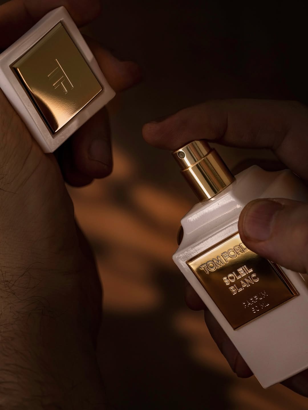 Tom Ford fragrance photography product photo: ivory white, brushed gold and espresso, glass and organic, dramatic light, image 9 of 9