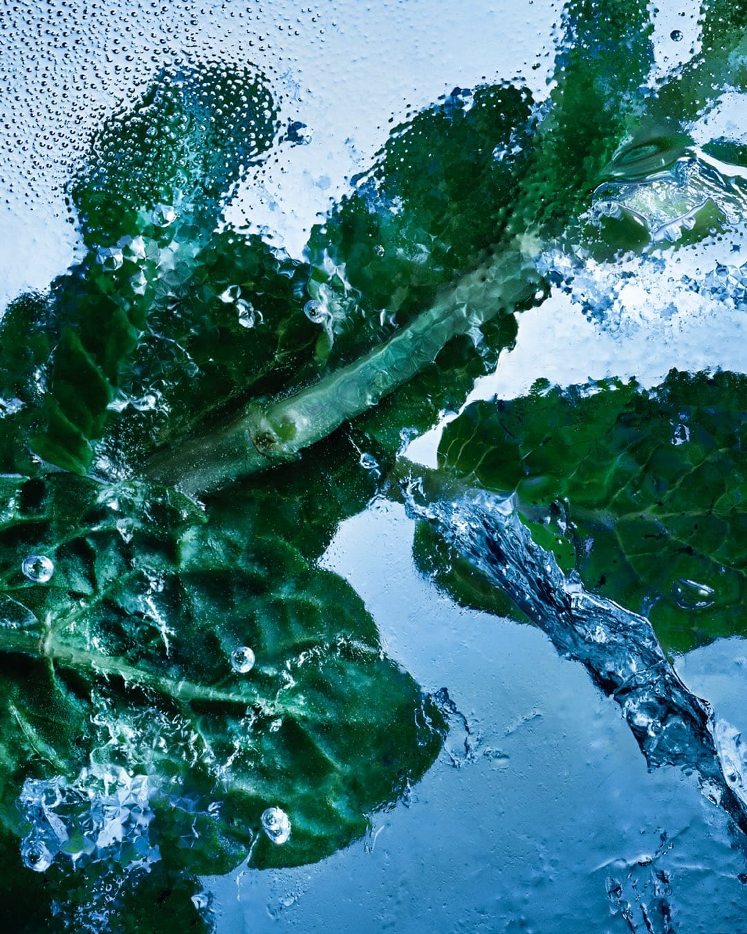 YSL Beauty Iced Cologne product photo: ice blue, black cap and silver label, organic, dramatic light, image 2 of 4