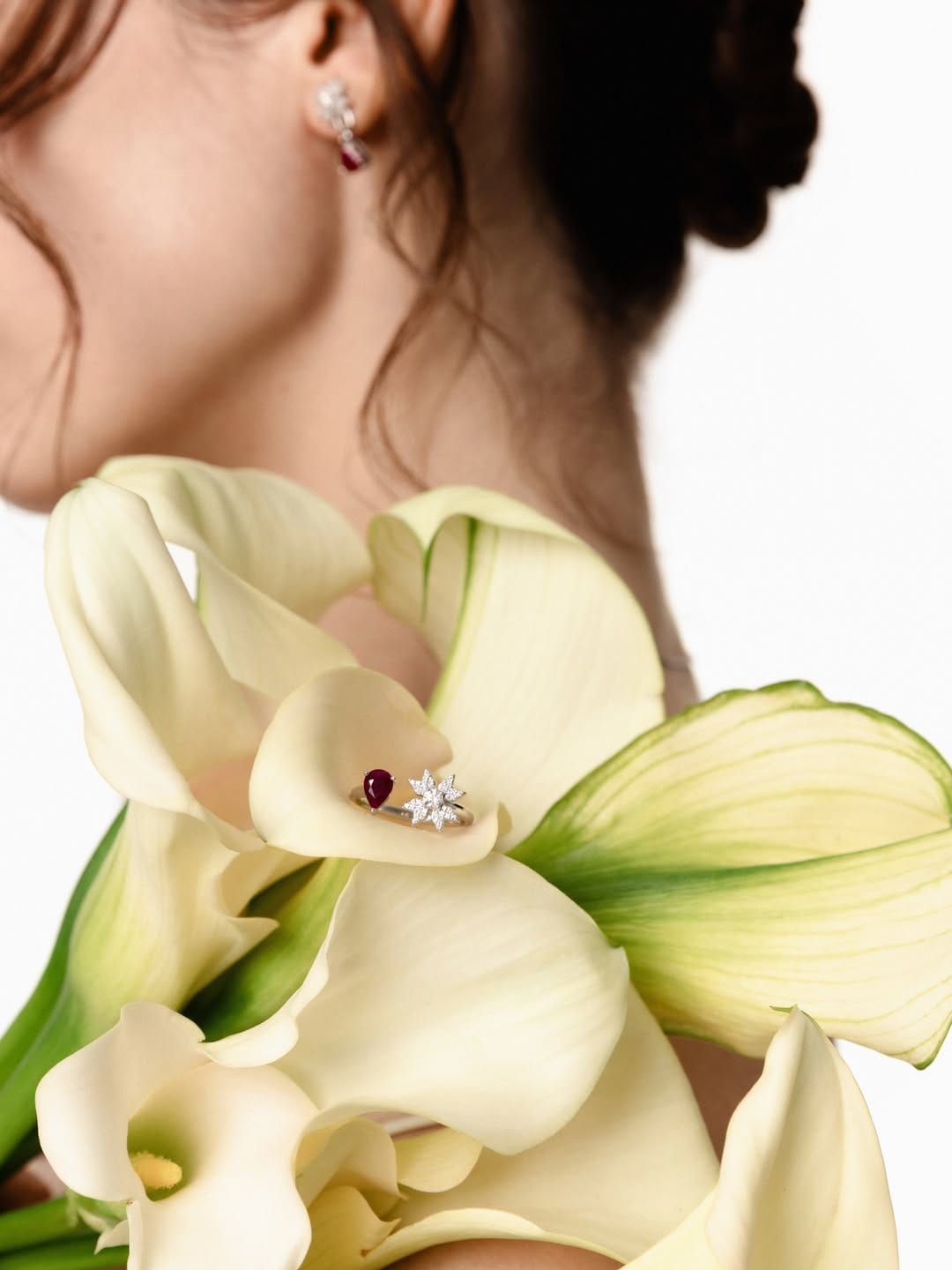 ZARINA Jewelry product photo: white gold and ruby red, skin and organic, soft light
